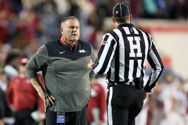 Arkansas head coach Sam Pittman speaks with a referee during Wednesday's Liberty Bowl win over Kansas.