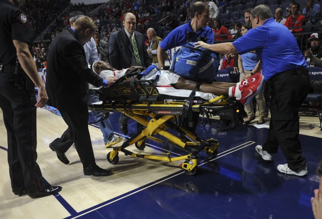 Medical personnel take Ole Miss guard Deandre Burnett off the court during the second half of the Rebels' win over Tennessee Tuesday at The Pavilion at Ole Miss. Brooks suffered a seizure during the game. He was released from the hospital later in the week.