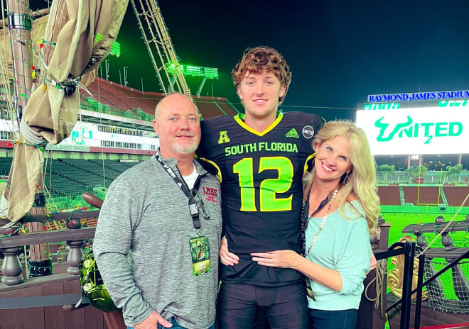 Gunnar Smith with his parents during a photo shoot in Raymond James Stadium during the visit