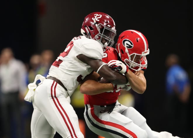 Georgia Bulldogs tight end Charlie Woerner (89) is tackled by linebacker Dylan Moses (32) after a catch by Woerner during the second quarter in the SEC championship game at Mercedes-Benz Stadium. Photo | USA Today