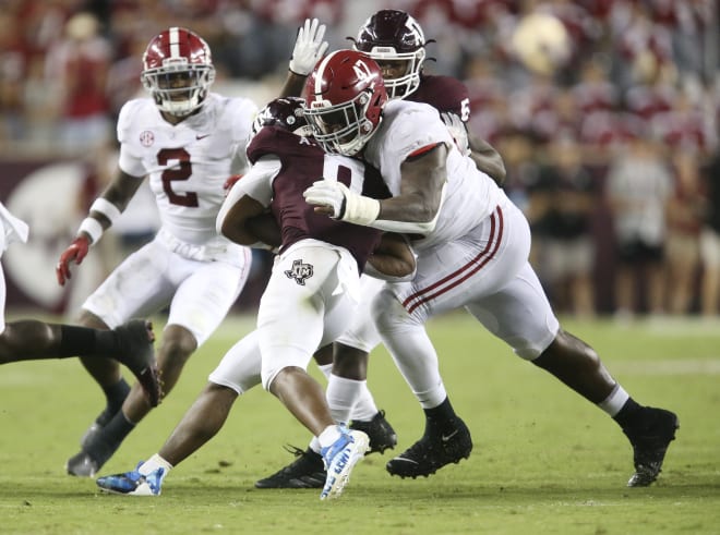 Texas A&M running back Devon Achane (6) is hit by Alabama defensive lineman Byron Young (47) at Kyle Field. Texas A&M defeated Alabama 41-38 on a field goal as time expired. Photo | Gary Cosby Jr.-USA TODAY Sports