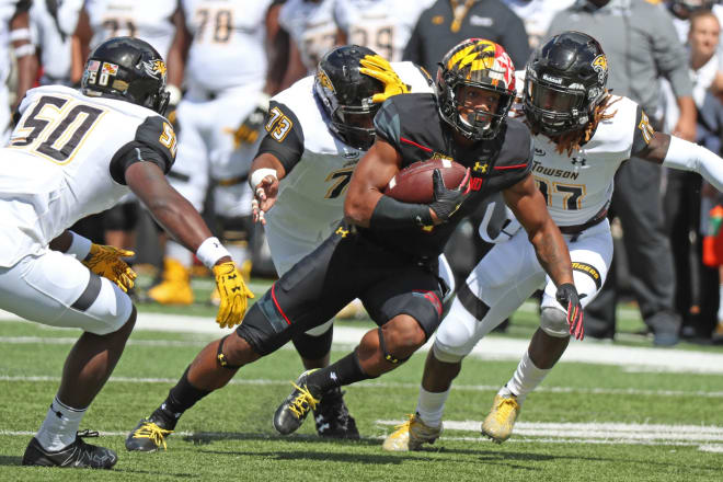 D.J. Moore (No. 1) broke numerous tackles during his 21-yard touchdown run against Towson.