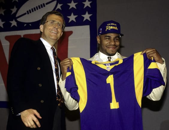 NFL commissioner Paul Tagliabue (left) stands with Notre Dame running back Jerome Bettis after the L.A. Rams selected Bettis in the first round of the 1993 NFL Draft.