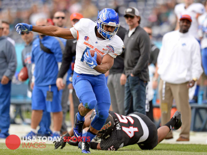 Boise State Broncos running back Jeremy McNichols (13) runs after a catch as Northern Illinois   Huskies linebacker Boomer Mays (45) defends during the first quarter in the 2015 Poinsettia Bowl at Qualcomm Stadium.