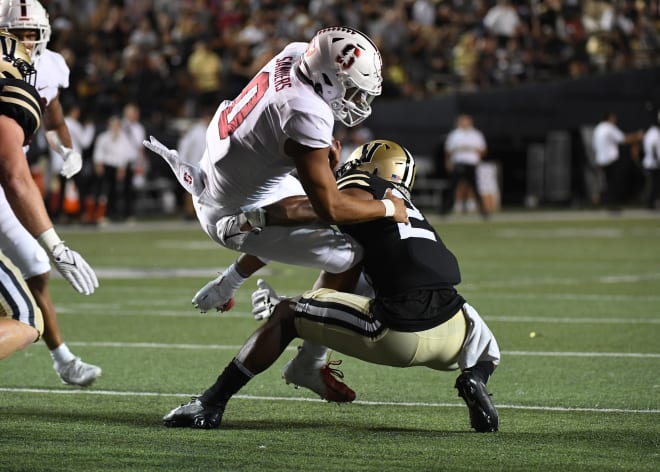 Brendon Harris, right, makes a tackle against Stanford during a game last season. 