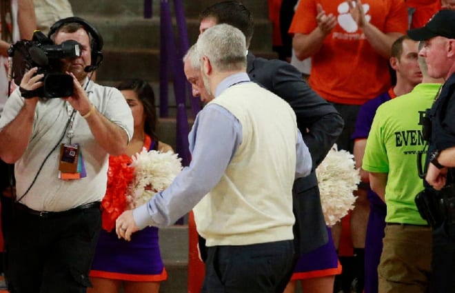 UNC trainer Doug Halverson (pictured) helps Roy Williams off the court Saturday night at Clemson.