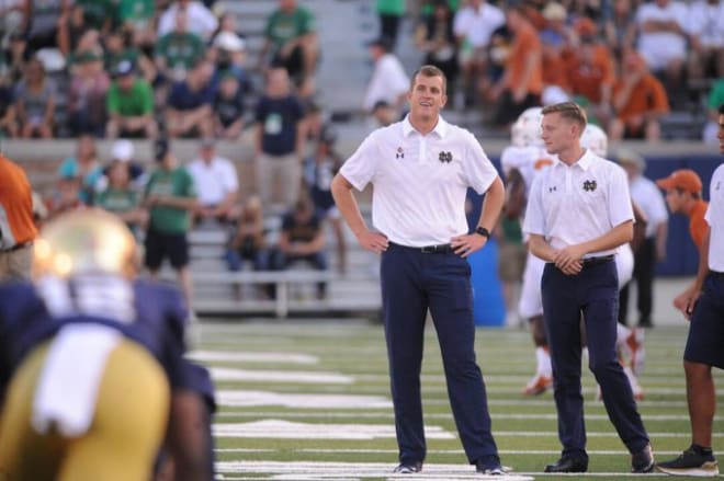 Former Notre Dame director of football operations Jason Michelson (left) on the field before a game