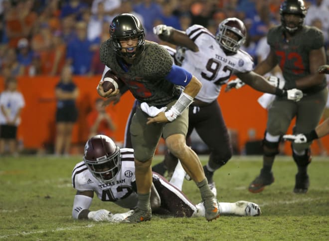 Oct 14, 2017; Gainesville, FL, USA; Florida Gators quarterback Feleipe Franks (13) runs with the ball as Texas A&M Aggies linebacker Otaro Alaka (42) attempted to defend during the second half at Ben Hill Griffin Stadium.