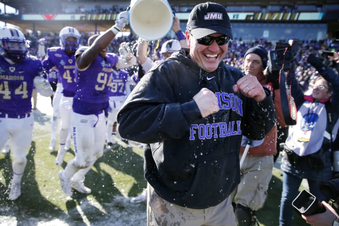 Former James Madison coach Mike Houston smiles after being dunked with Gatorade by his players during the Dukes' 28-14 win over Youngstown State in the FCS national championship game on Jan. 7, 2017.
