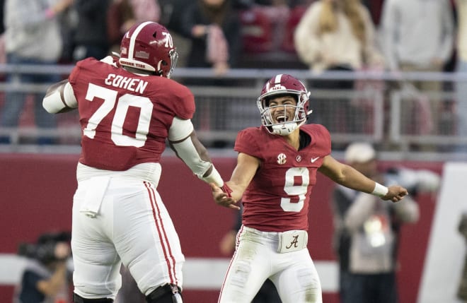 Alabama Crimson Tide quarterback Bryce Young (9) celebrates with Alabama Crimson Tide offensive lineman Javion Cohen (70) after a touchdown against the Auburn Tigers during the first half at Bryant-Denny Stadium. Photo | Marvin Gentry-USA TODAY Sports