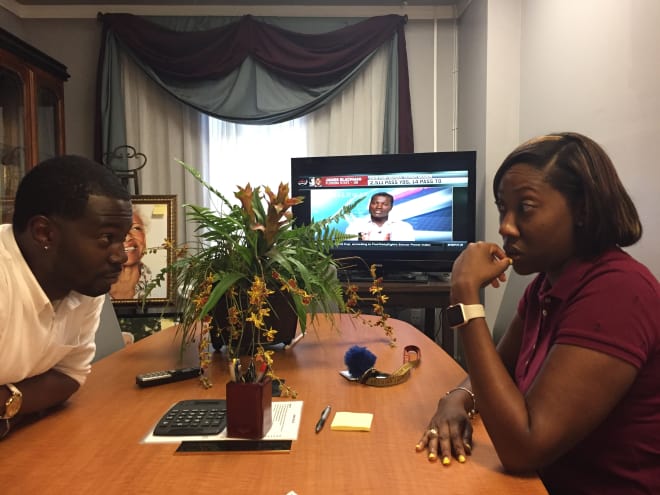 Rickey Butts, left, and Khadeidra Fletcher talk while listening to a television report about James Blackman.