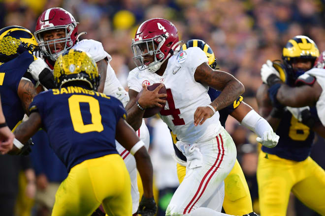 Alabama Crimson Tide quarterback Jalen Milroe (4) runs against Michigan Wolverines defensive back Mike Sainristil (0) in the fourth quarter in the 2024 Rose Bowl college football playoff semifinal game at Rose Bowl. Photo | Gary A. Vasquez-USA TODAY Sports