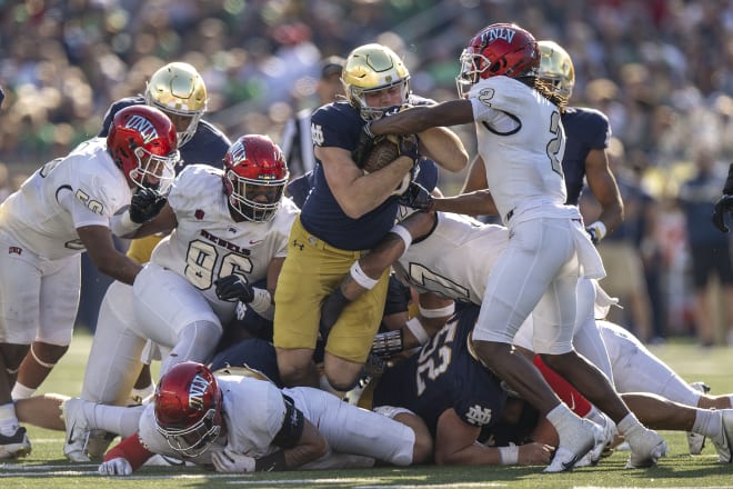 Notre Dame tight end/QB sneaker Mitchell Evans (with ball) lunges forward for a first down, Oct. 22 vs. UNLV.