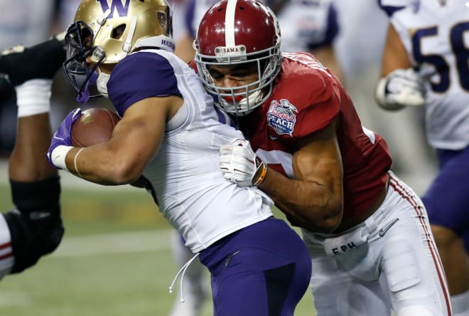 Alabama Crimson Tide defensive back Minkah Fitzpatrick (29) tackles Washington Huskies running back Myles Gaskin (9) for a short gain during the fourth quarter in the 2016 CFP Semifinal at the Georgia Dome.