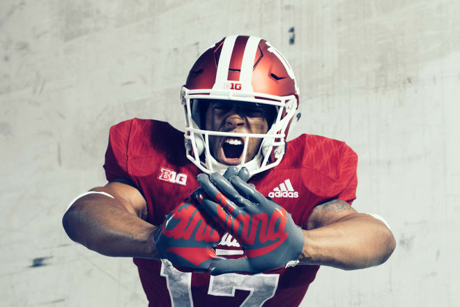 the stone colored adizero 5-Star 5.0 gloves feature a white oversized graphic of the “Indiana” script logo on the palms.