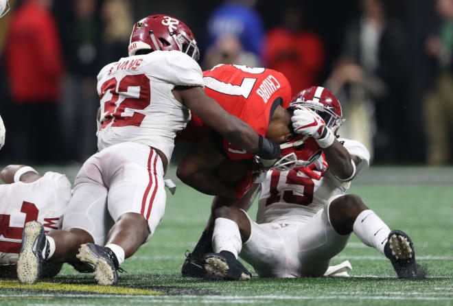 Alabama Crimson Tide defensive back Ronnie Harrison (15) and linebacker Rashaan Evans (32) combine to tackle Georgia Bulldogs running back Nick Chubb (27) during the fourth quarter in the 2018 CFP national championship college football game at Mercedes-Benz Stadium. Photo | USA Today