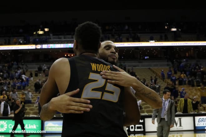 Woods embraces a Kentucky player after the game