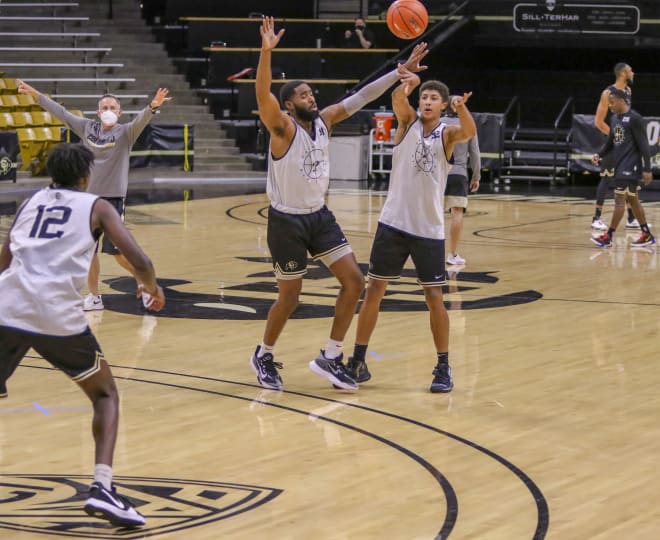 Freshman guard Dominique Clifford passes the ball to fellow freshman Jabari Walker (12)