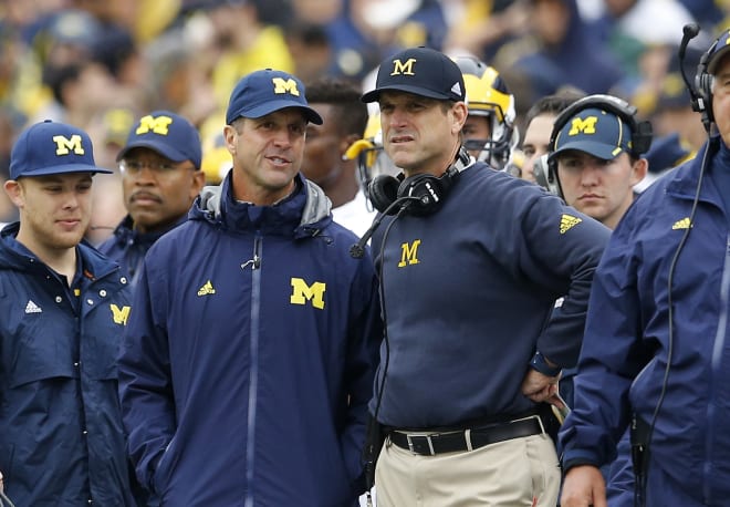 Michigan Wolverines football coach Jim Harbaugh with brother John Harbaugh in 2015 when the Wolverines played at Maryland.