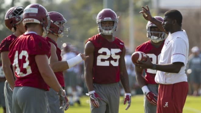 Alabama defensive backs coach Derrick Ansley, right, talks with players during the Crimson Tide's spring camp. Photo | Laura Chramer