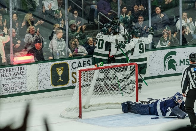 Michigan State senior Jagger Joshua is mobbed by team members after scoring against Penn State Saturday, Jan. 14, 2023. Joshua went on to score a hat-trick to help Michigan State win in a shoot out.