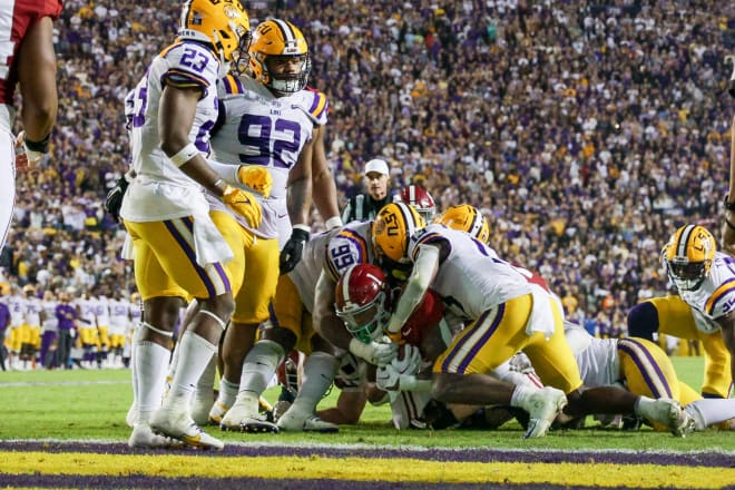 Alabama Crimson Tide running back Jahmyr Gibbs (1) rushes against LSU Tigers linebacker Micah Baskerville (23) and LSU Tigers defensive tackle Jaquelin Roy (99) during the second half at Tiger Stadium. Photo | Stephen Lew-USA TODAY Sports