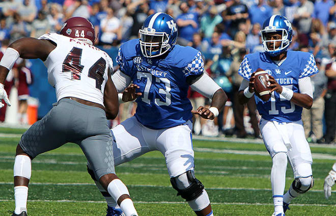 Kentucky quarterback Stephen Johnson dropped back behind the pass protection of offensive tackle Kyle Meadows in Saturday's win over Eastern Kentucky. 