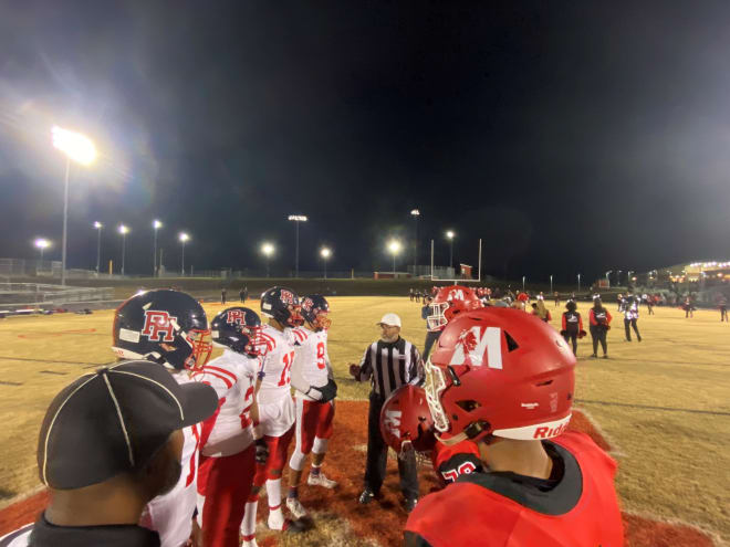 Captains for Patrick Henry and Matoaca meet at midfield for the coin toss