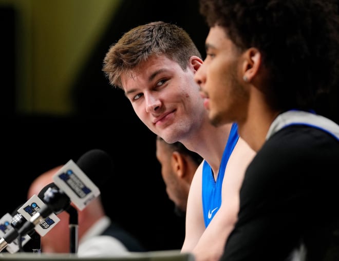 Kyle Filipowski looks at Tyrese Proctor during Thursday's press conference. 