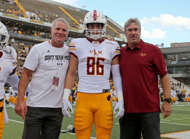 Philadelphia Eagles coach Doug Pederson (right), a former ULM quarterback, poses with his son, ULM tight end Josh Pederson (86) and a random fan prior to the Fighting Scholars' blowout victory at Southern Miss last Saturday. The Fightins are undefeated this season and well on their way to a Super Bowl title. 