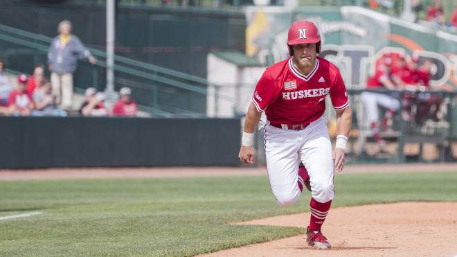 Senior catcher Griffin Everitt runs home.