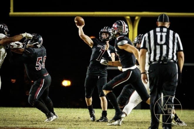 Red Mountain QB Hyrum Boren delivers a 57-yard strike to George Ramirez to tie the game in the second quarter agasinst Desert Ridge.  (Photo courtesy of Jason Digos Photography)