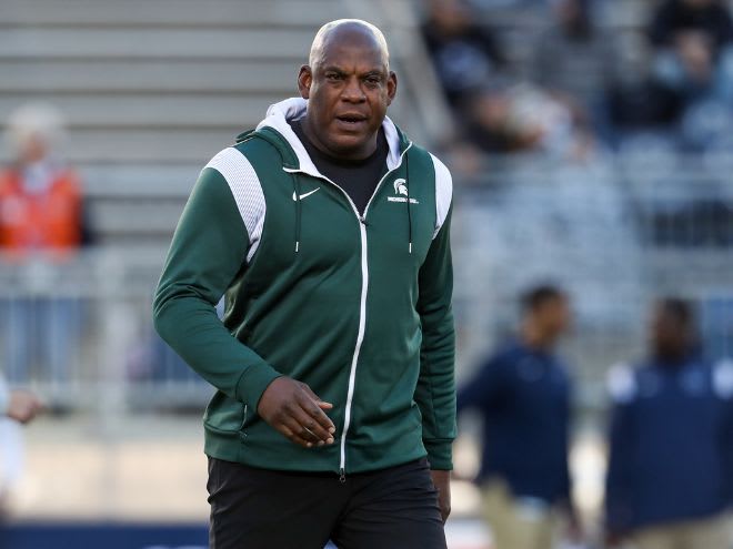 Mel Tucker walks the field during warmups prior to a Michigan State football game