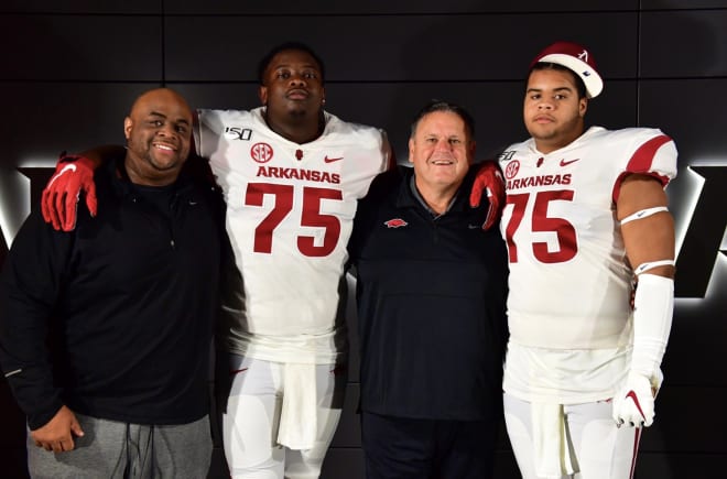 Arkansas coaches Brad Davis and Sam Pittman with OL targets Ray Curry and Marcus Henderson.