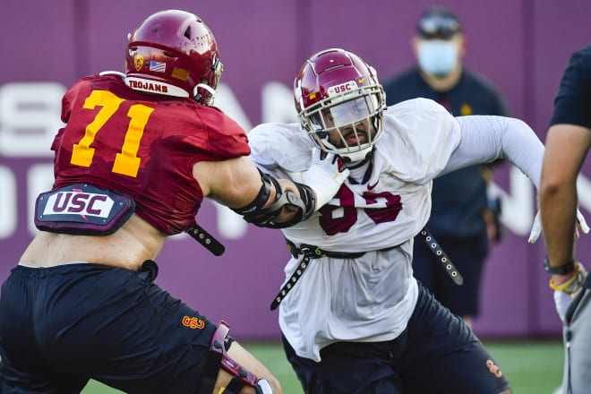 Offensive lineman Liam Jimmons goes against defensive tackle Marlon Tuipulotu in practice Monday.