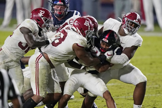 Alabama defenders smother Mississippi running back Jerrion Ealy.