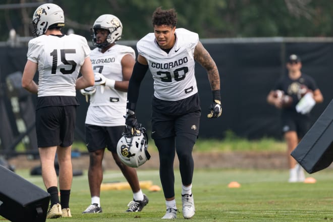 Robert Barnes is flanked by fellow grad transfer linebacker Jack Lamb (15) and redshirt freshman Marvin Ham  II (7)