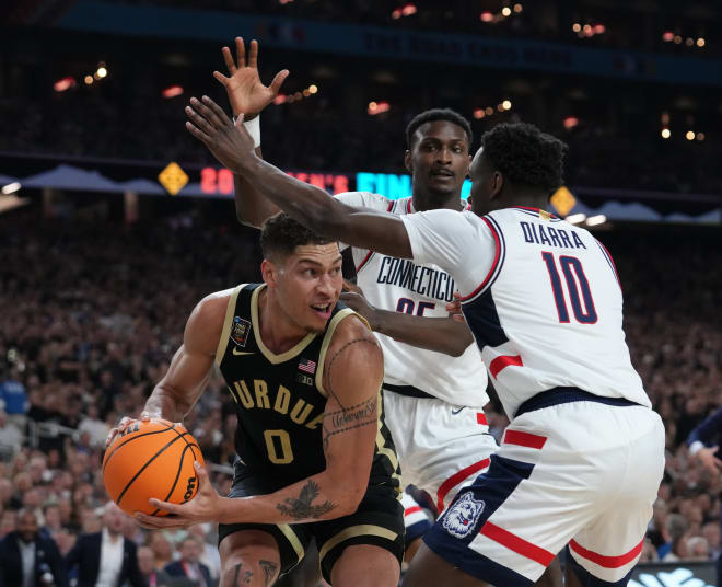 Purdue Boilermakers forward Mason Gillis (0) is guarded by Connecticut Huskies guard Hassan Diarra (10) during the Men's NCAA national championship game at State Farm Stadium in Glendale on April 8, 2024.
