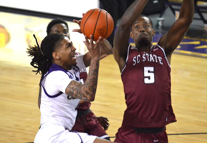 ECU's Brandon Suggs drives on South Carolina State's Isaiah Felder in Tuesday night's season opener.