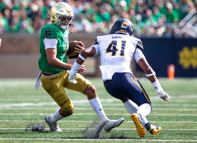 Notre Dame quarterback Drew Pyne (10) tries to evade pressure during ND's 24-17 win over Cal, Saturday at Notre Dame Stadium.