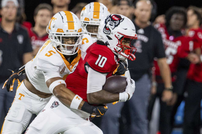 Tennessee defensive back Christian Harrison (5) tackles North Carolina State wide receiver Kevin Concepcion (10) during the first half of an NCAA college football game Sunday, Sept. 8, 2024, in Charlotte, N.C. (AP Photo/Scott Kinser)