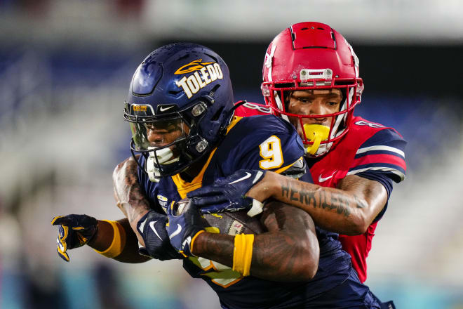 Liberty Flames cornerback Daijahn Anthony (8) tackles Toledo Rockets tight end Jamal Turner (9) during the second quarter in the 2022 Boca Raton Bowl at FAU Stadium. Mandatory Credit: Rich Storry-USA TODAY Sports