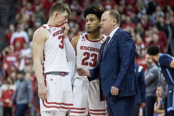 Greg Gard (right) speaks to Connor Essegian (3) and Chucky Hepburn (23) during Wisconsin's victory over Liberty on March 19