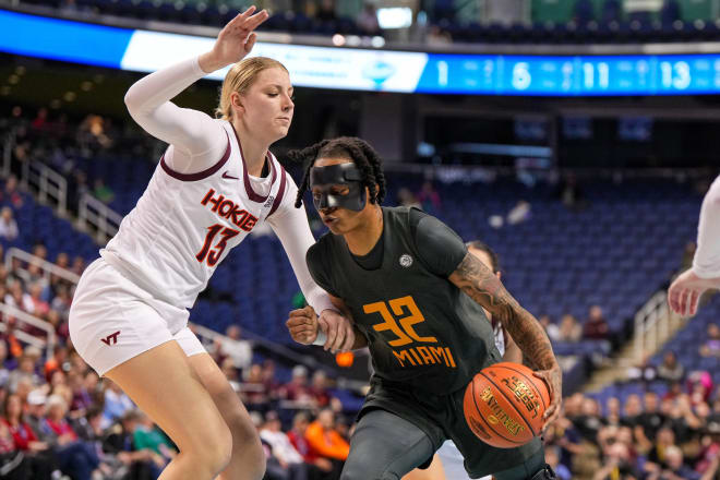 Mar 8, 2024; Greensboro, NC, USA; Miami Hurricanes forward Lazaria Spearman (32) drives around Virginia Tech Hokies center Clara Strack (13) in the second half at Greensboro Coliseum.