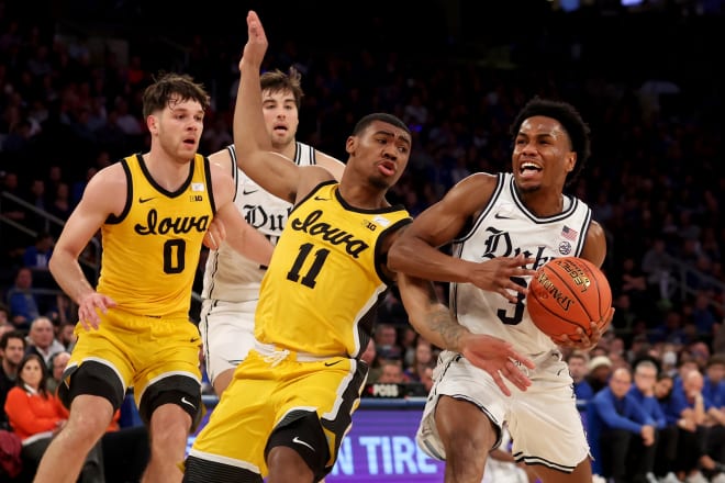 Duke's Jeremy Roach, right, drives against Iowa's Tony Perkins during Tuesday night's game at Madison Square Garden. 