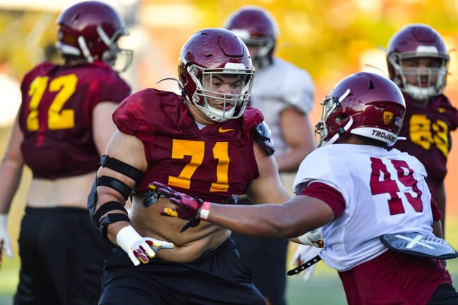 Liam Jimmons goes against freshman defensive end Tuli Tuipulotu on Monday.