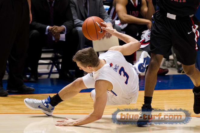 Boise State's Anthony Drmic is fouled while hustling after a loose ball