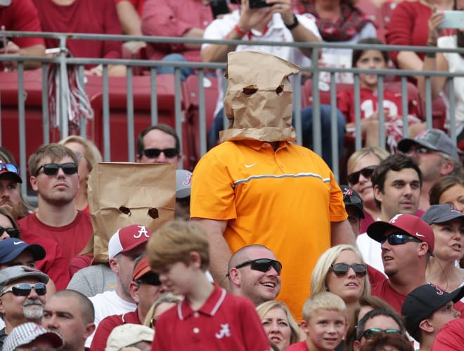 Tennessee Volunteers fans shield their faces during the game against Alabama Crimson Tide during the second quarter at Bryant-Denny Stadium.