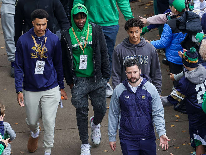 Michigan is making a run at hiring Notre Dame director of recruiting Chad Bowden (lower right) away from the Irish.
