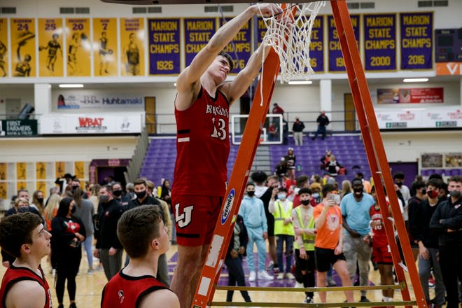 Barnhizer cuts down the nets after winning the sectional title.